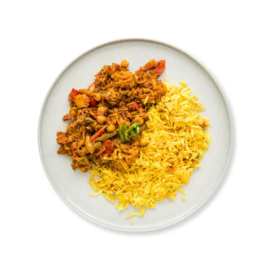 Vegetable Jalfrezi & Rice. Spicy jalfrezi curry packed with onions, chickpeas, red peppers, and green beans served with cumin basmati rice.